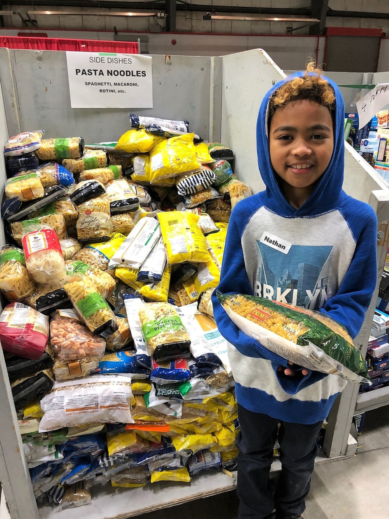 Student in front of food hamper